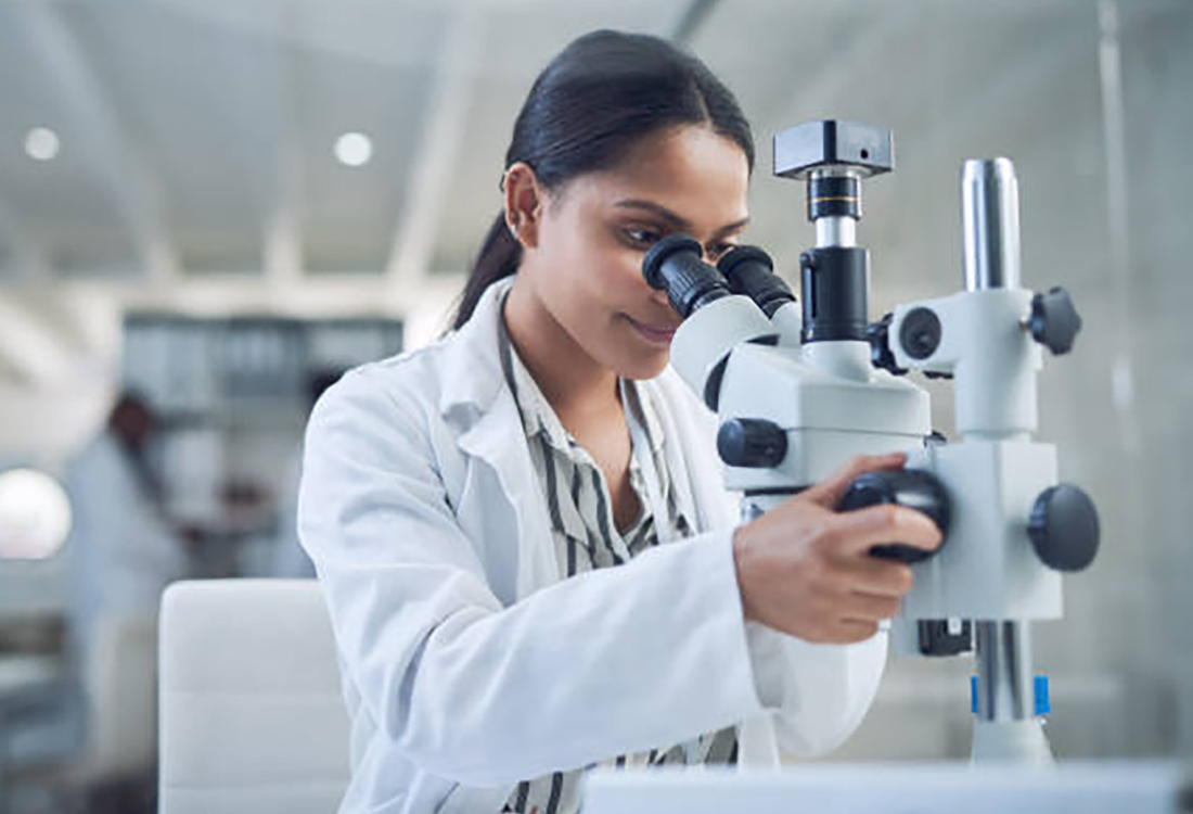 Shot of a young scientist using a microscope while conducting research in a laboratory